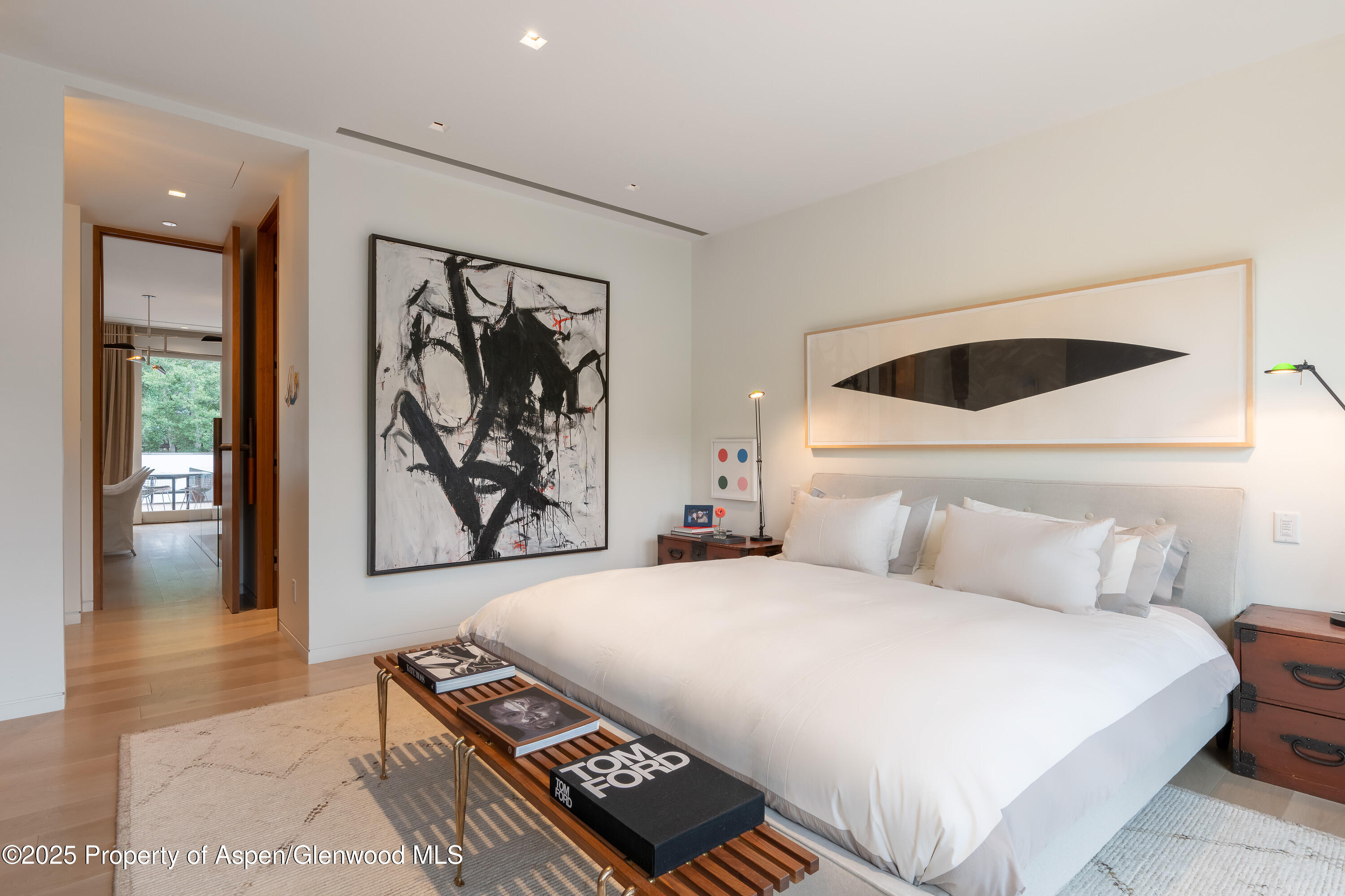 100 East Cooper Avenue, Unit 11 Aspen, CO 81611 - Photo 23 of 44 a bedroom with a bed and a painting on the wall