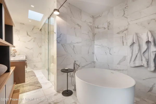 a bathroom with a bathtub and shower