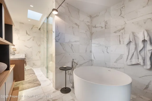 a bathroom with a bathtub and shower