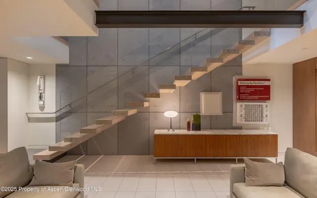 a living room with furniture and stairs