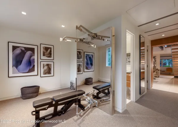 a bathroom with a granite countertop sink a toilet a large mirror and shower