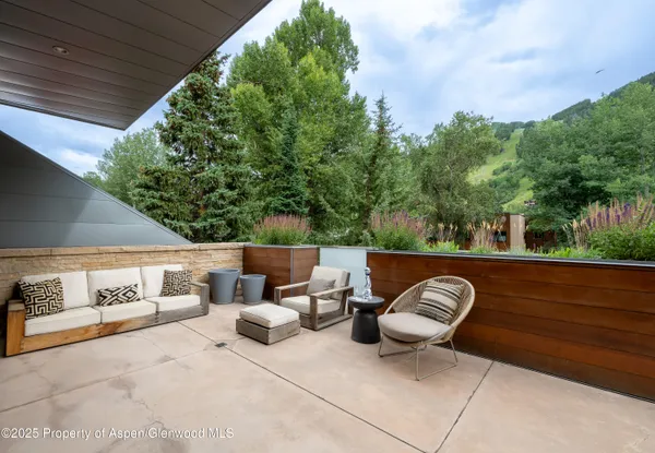 a view of a patio with two chairs and a table