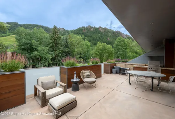 a view of patio with couches and a fire pit