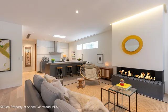 a living room with furniture a dining table and kitchen view