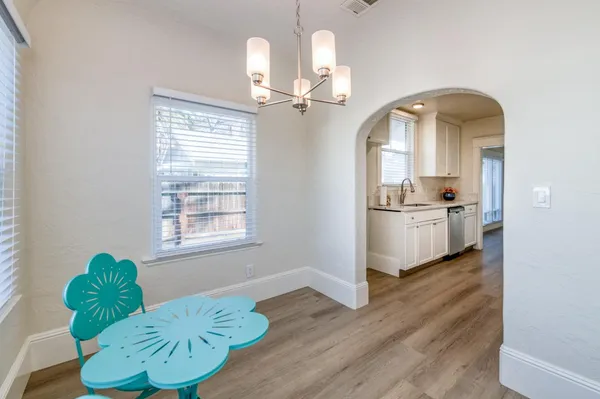 a view of a kitchen with a sink and wooden floor