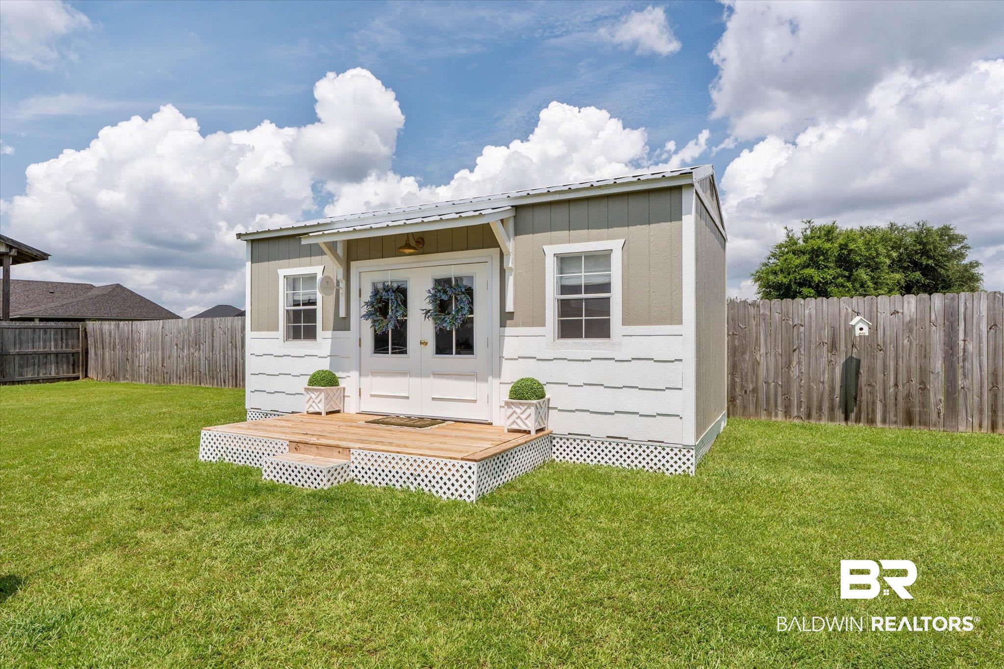 9074 Moses Way Theodore, AL 36582 - Photo 46 of 52 Freestanding outdoor structure featuring a metal roof, dual entry doors, and two windows
