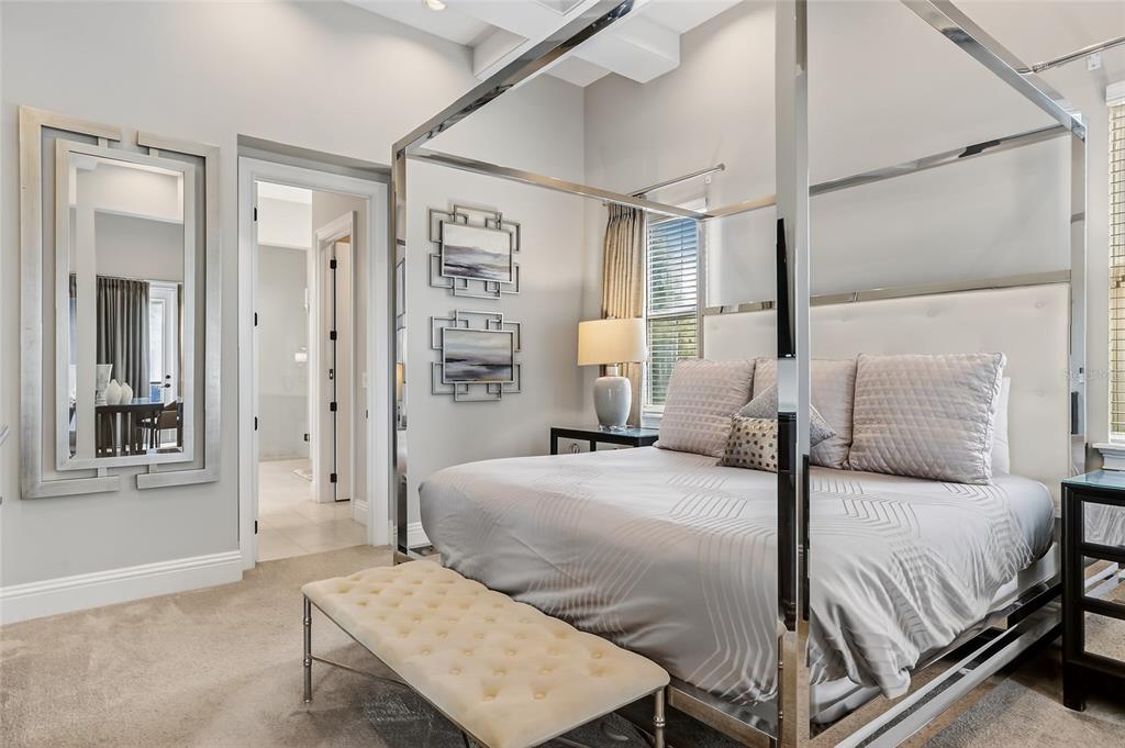 580 Muirfield Loop Reunion, FL 34747 - Photo 17 of 55 a bedroom with a bed and a table with the mirror