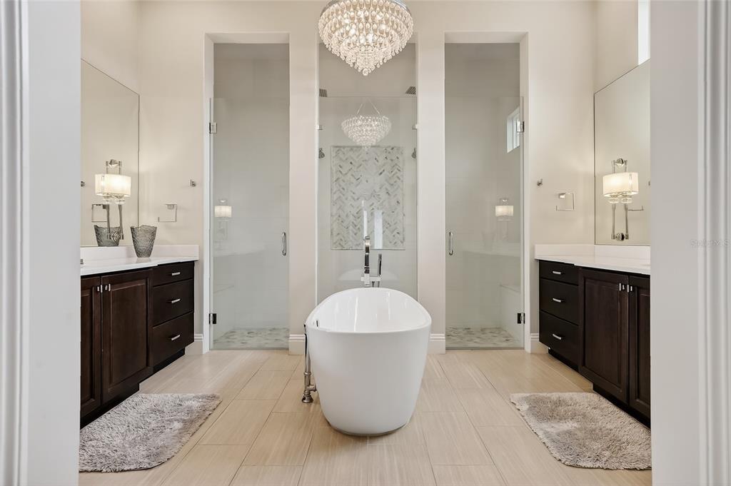 580 Muirfield Loop Reunion, FL 34747 - Photo 18 of 55 a spacious bathroom with a sink vanity granite and a mirror