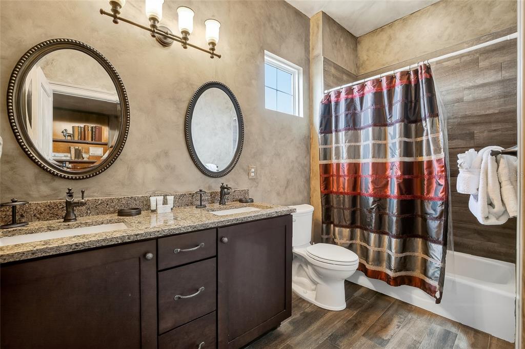 580 Muirfield Loop Reunion, FL 34747 - Photo 23 of 55 a bathroom with a double vanity sink and a mirror