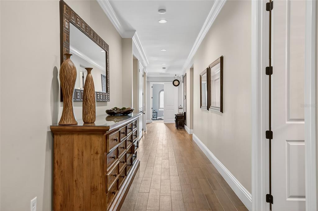580 Muirfield Loop Reunion, FL 34747 - Photo 30 of 55 a hallway with wooden floor and staircase