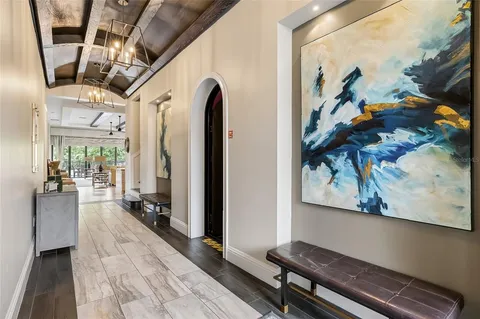 a hallway with wooden floor and furniture