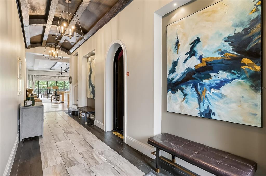 580 Muirfield Loop Reunion, FL 34747 - Photo 3 of 55 a hallway with wooden floor and furniture