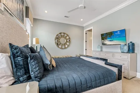 a bedroom with a large bed and a balcony view