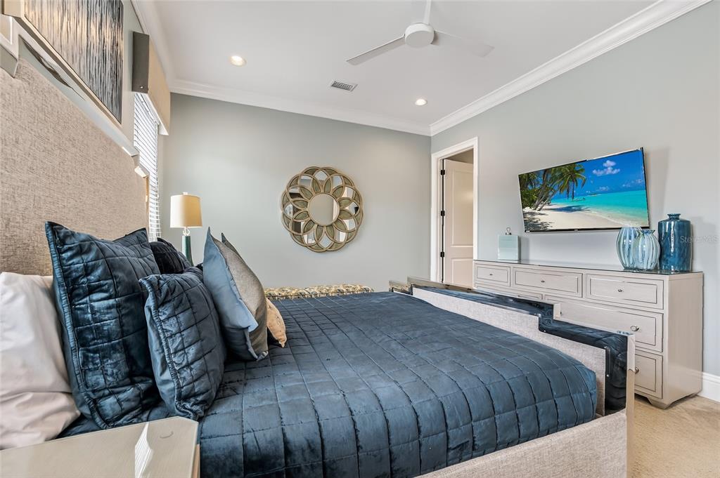 580 Muirfield Loop Reunion, FL 34747 - Photo 31 of 55 a bedroom with a bed and a flat screen tv