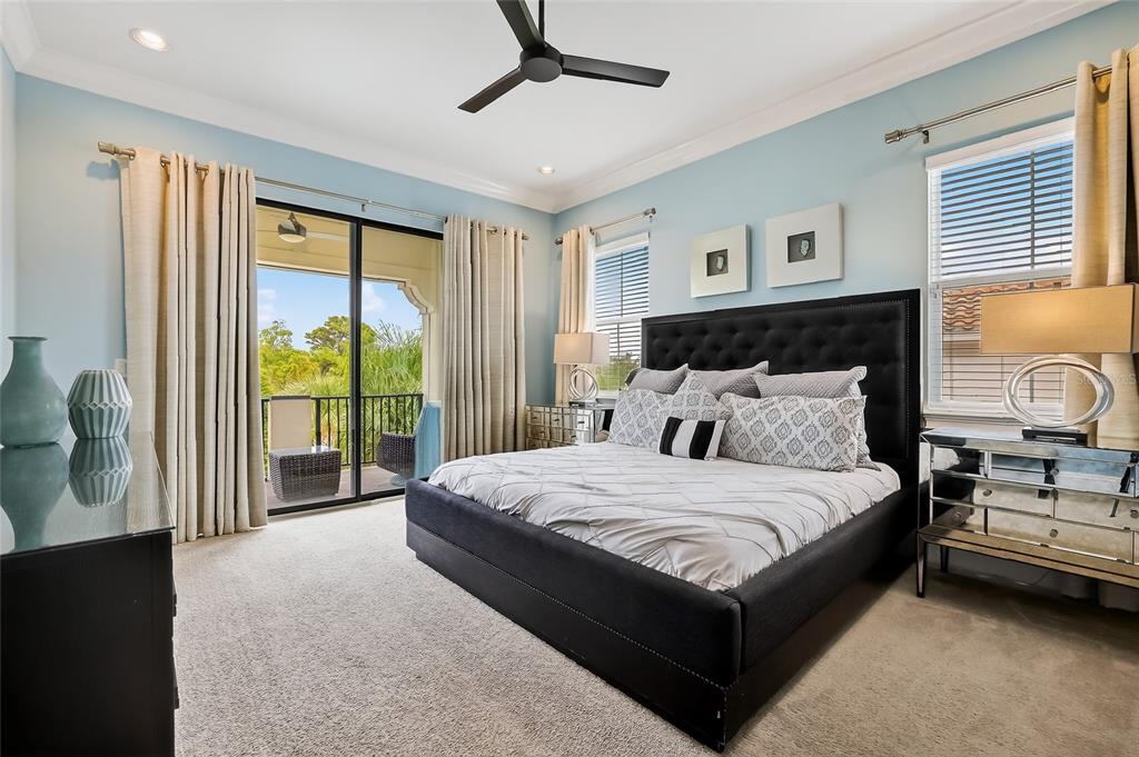 580 Muirfield Loop Reunion, FL 34747 - Photo 33 of 55 a bedroom with a large bed and a balcony view