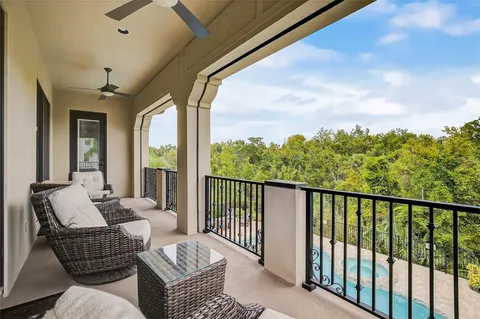 a dining room with furniture water view and a floor to ceiling window