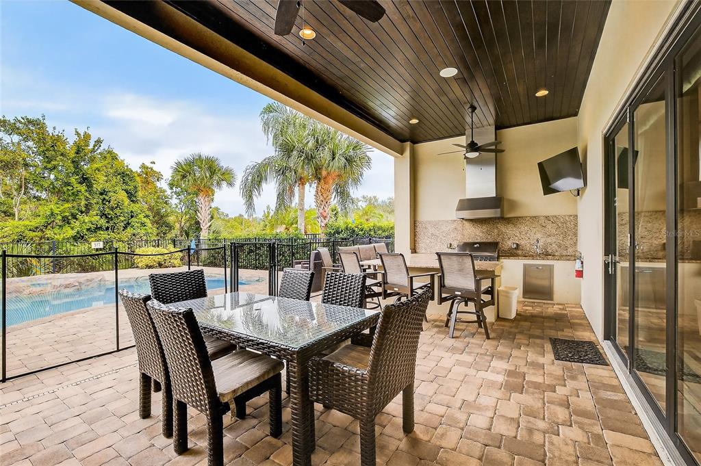 580 Muirfield Loop Reunion, FL 34747 - Photo 39 of 55 a dining room with furniture and a floor to ceiling window