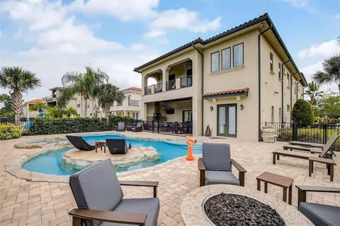a view of a house with swimming pool and furniture