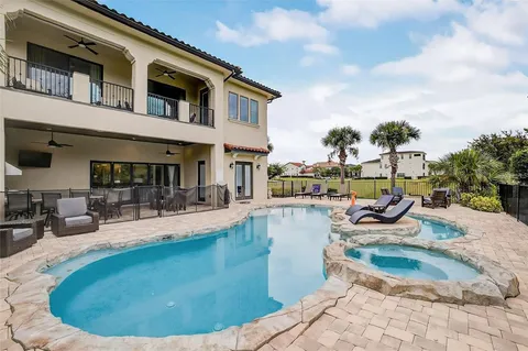 an aerial view of residential houses with outdoor space and parking