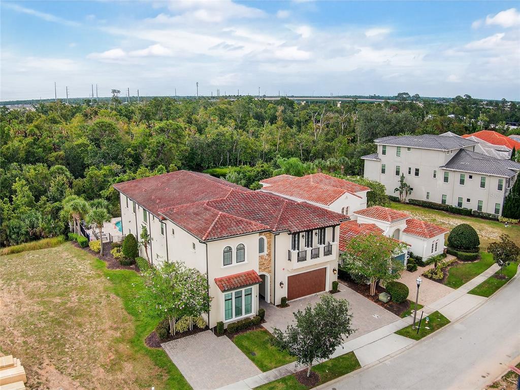 580 Muirfield Loop Reunion, FL 34747 - Photo 47 of 55 a view of a house with a garden and yard