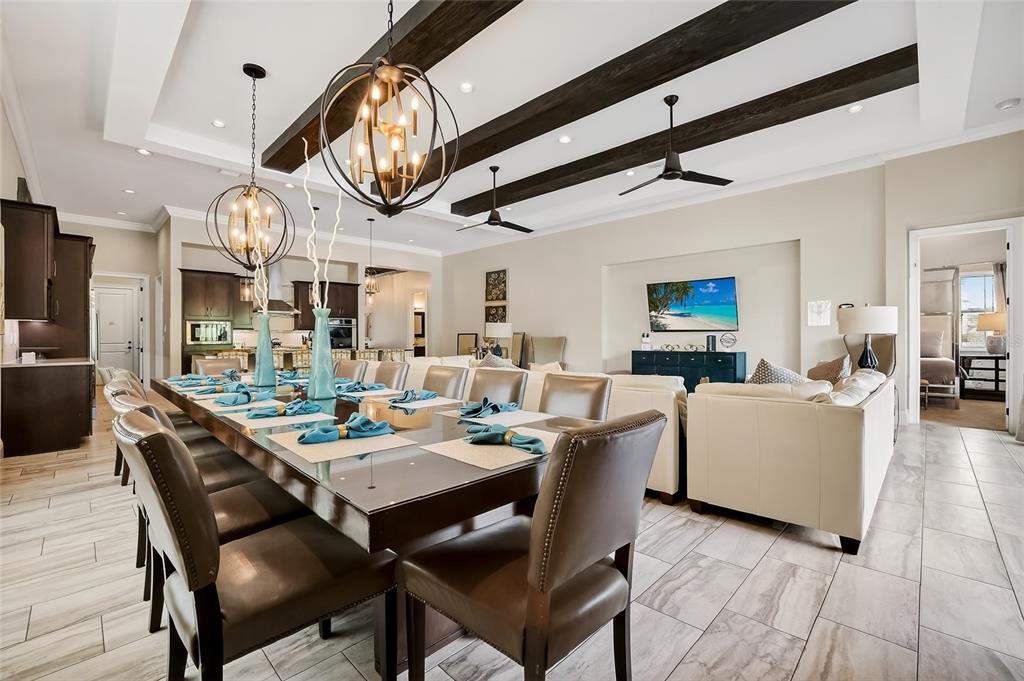 580 Muirfield Loop Reunion, FL 34747 - Photo 7 of 55 a dining room with wooden floor a chandelier a wooden table and chairs