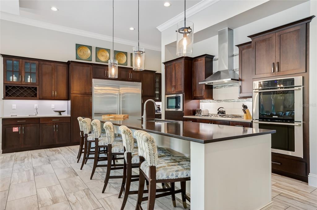580 Muirfield Loop Reunion, FL 34747 - Photo 9 of 55 a kitchen with stainless steel appliances kitchen island granite countertop a refrigerator and a stove top oven