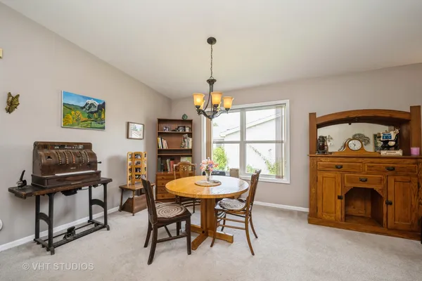 a dining room with furniture and a fireplace