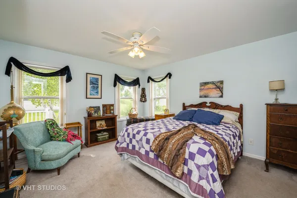 a bedroom with a bed couch and window
