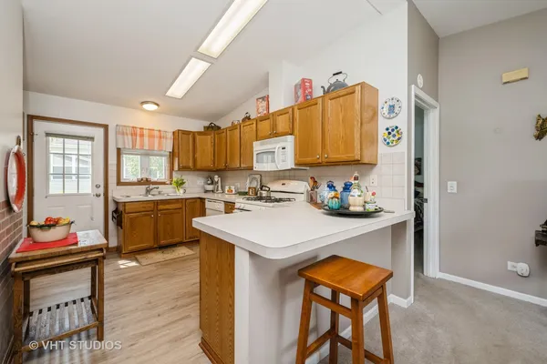 a kitchen with a sink appliances and cabinets