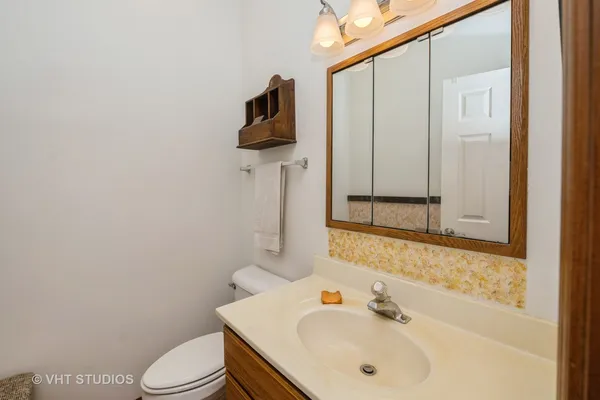 a bathroom with a sink toilet and mirror