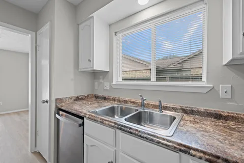 a kitchen that has a sink and cabinets