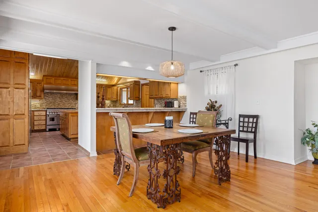 a living room with furniture a flat screen tv and a floor to ceiling window