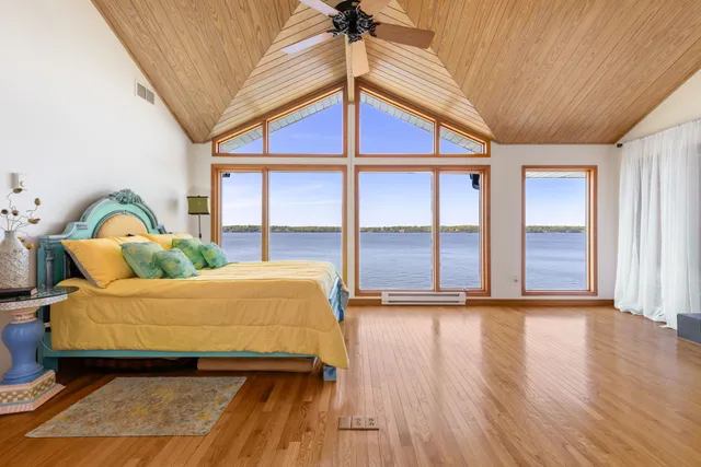 a bedroom with furniture and large windows