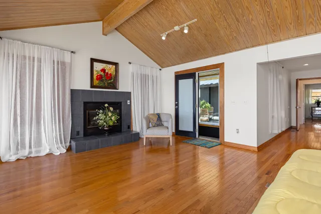a spacious bedroom with a large bed and a chandelier