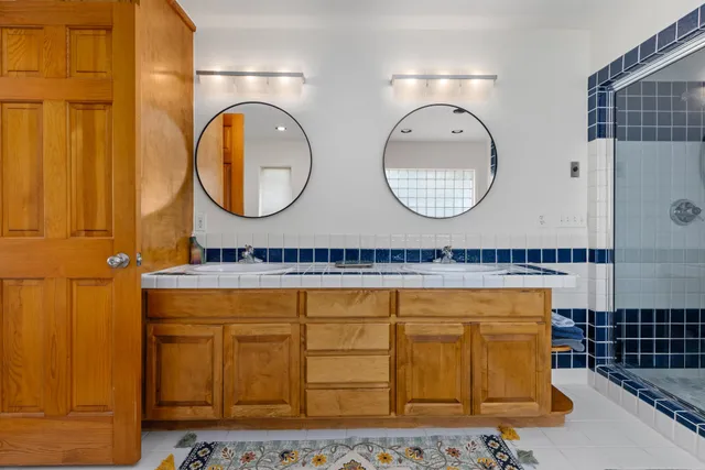 an aerial view of residential houses with outdoor space and parking