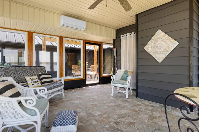 a couple of benches sitting in front of a house