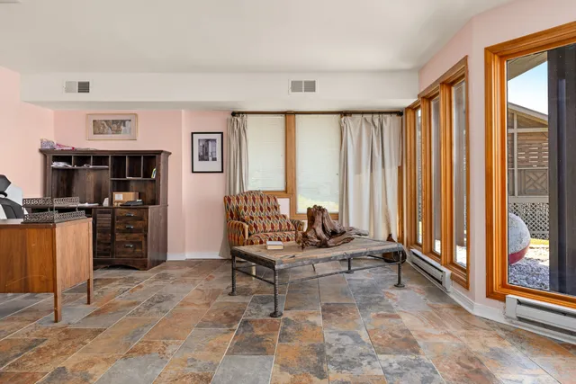 a view of a bedroom with furniture and window