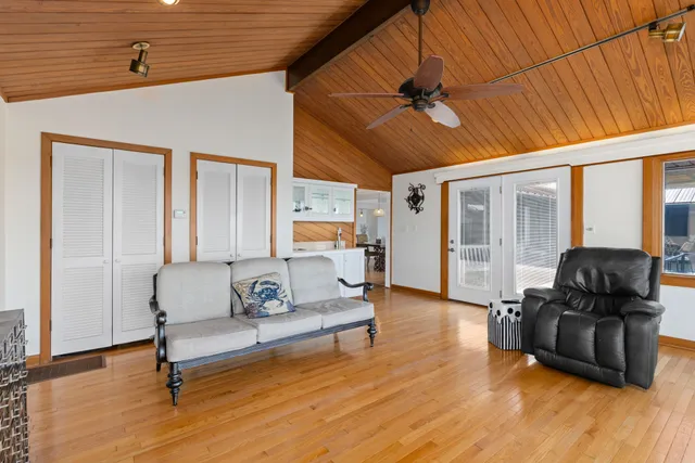 a bed with white sheets and pillows on it