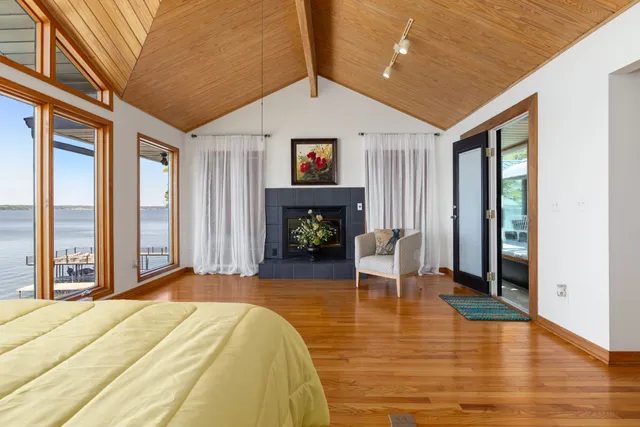 a roof deck with table and chairs and potted plants