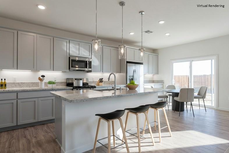 271 Piper Lane Colusa, CA 95932 - Photo 17 of 39 a kitchen with stainless steel appliances granite countertop a stove a sink a microwave a dining table and chairs with wooden floor