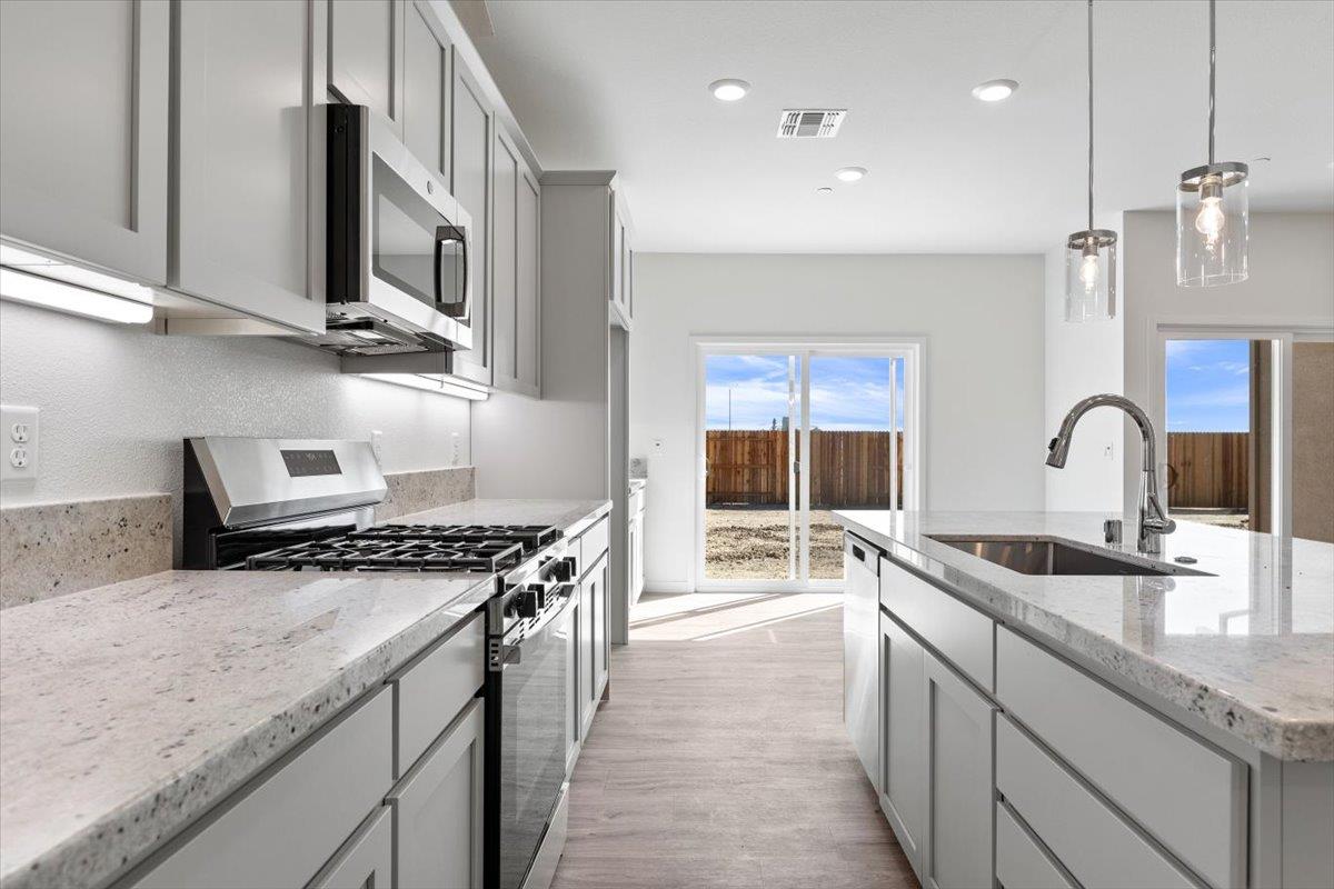 271 Piper Lane Colusa, CA 95932 - Photo 18 of 39 a kitchen with stainless steel appliances granite countertop a sink stove and cabinets