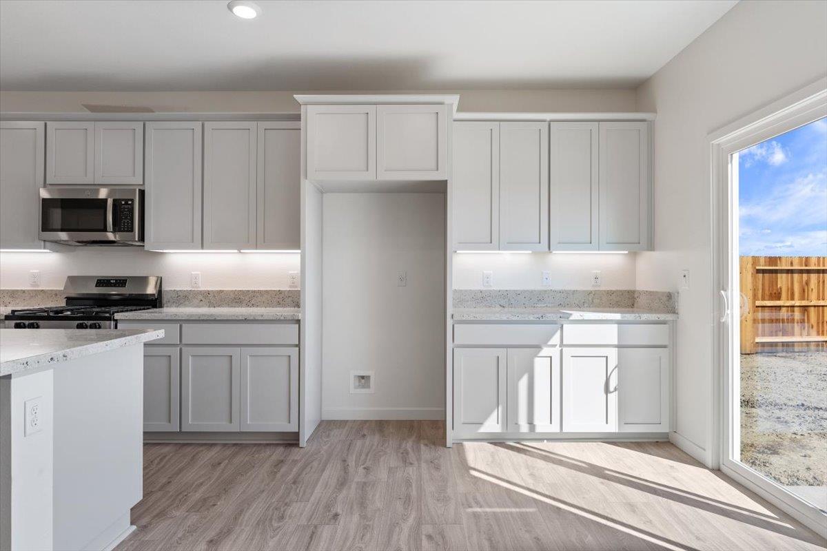 271 Piper Lane Colusa, CA 95932 - Photo 21 of 39 a kitchen with granite countertop cabinets stainless steel appliances and a window