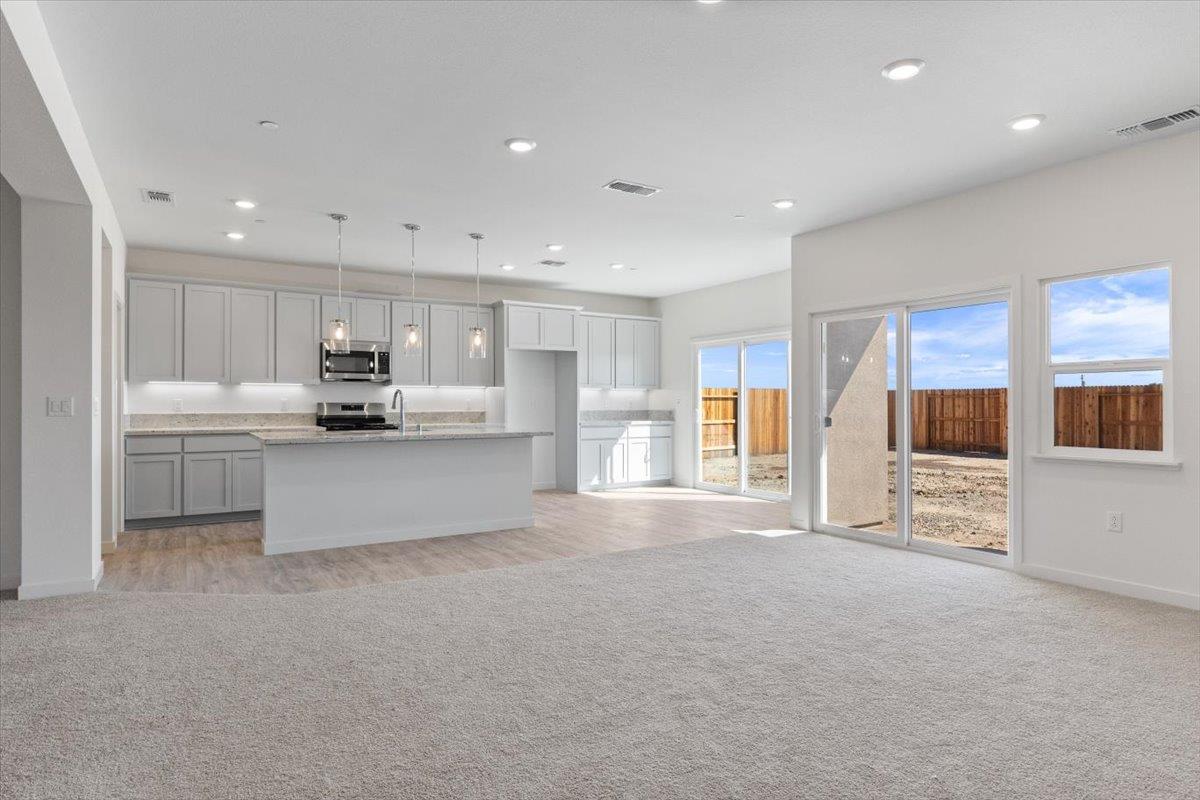 271 Piper Lane Colusa, CA 95932 - Photo 3 of 39 a large white kitchen with stainless steel appliances kitchen island a large counter top and a stove