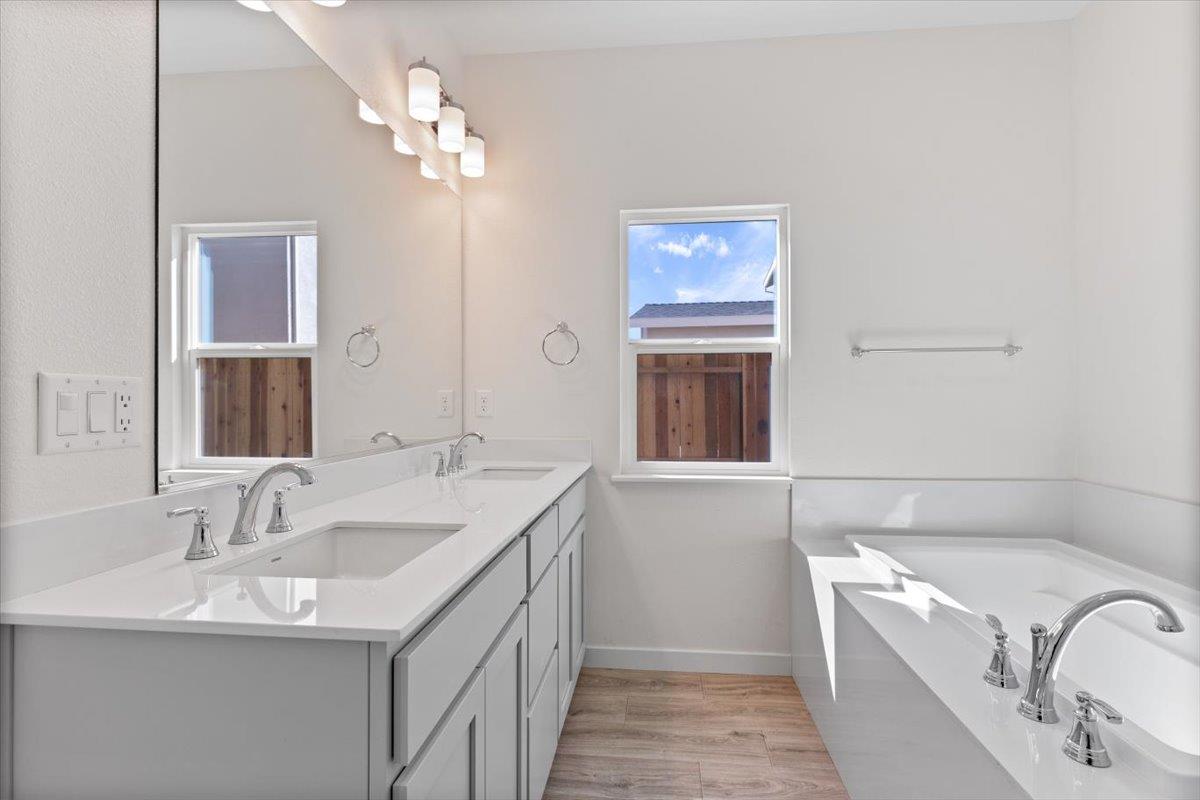 271 Piper Lane Colusa, CA 95932 - Photo 35 of 39 a bathroom with a granite countertop double vanity sink a mirror and a bathtub