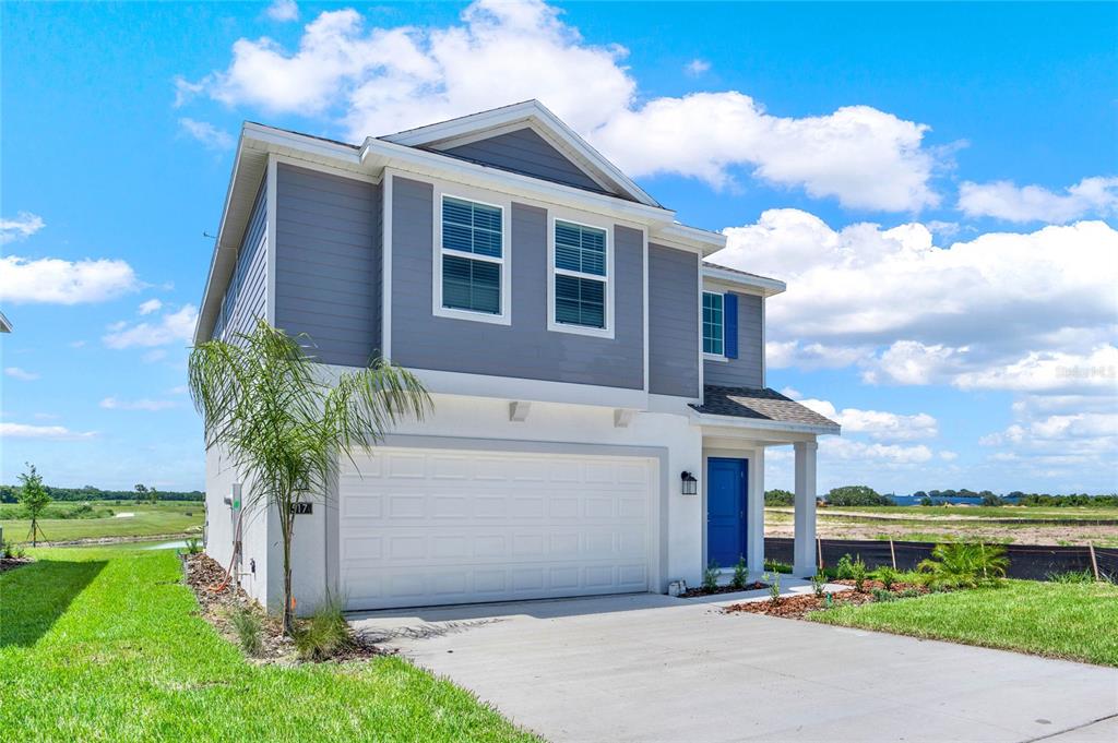 517 Bell Prairie Circle Lake Wales, FL 33859 - Photo 3 of 42 a front view of a house with garden