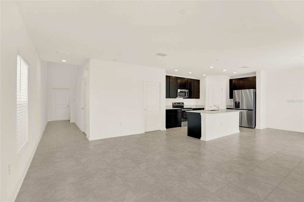 517 Bell Prairie Circle Lake Wales, FL 33859 - Photo 4 of 42 a view of kitchen with kitchen island granite countertop stainless steel appliances refrigerator and microwave