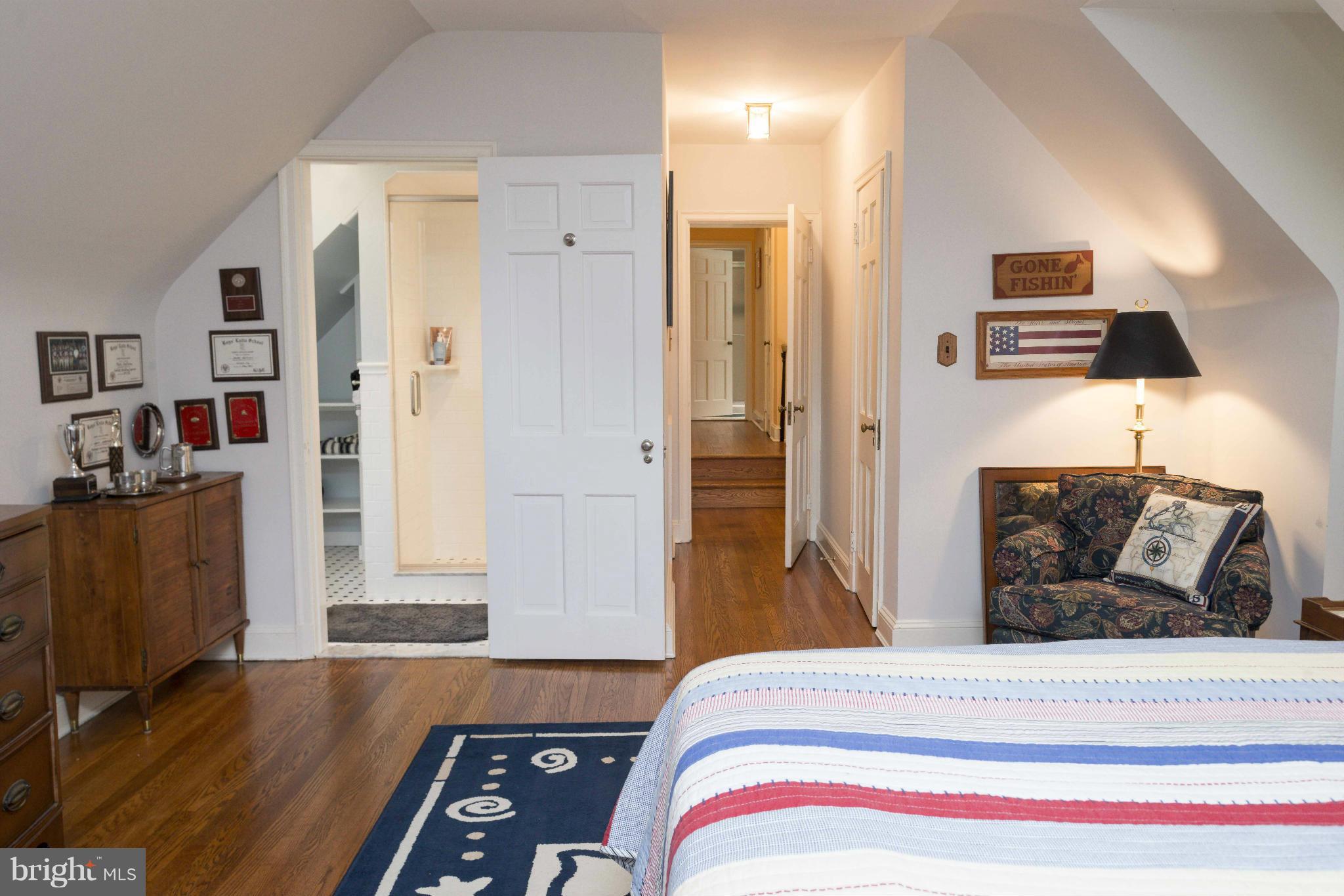 1908 Ruxton Road Baltimore, MD 21204 - Photo 17 of 29 a bedroom with a bed and wooden floor