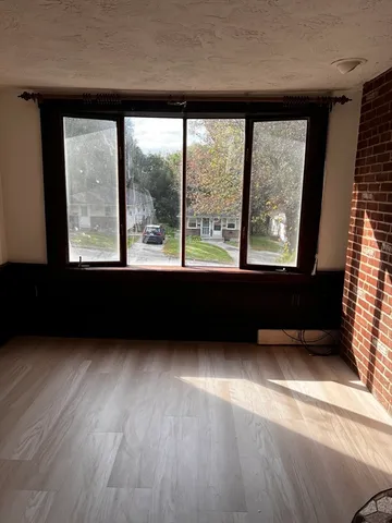 a view of an empty room with a window and a floor to ceiling window