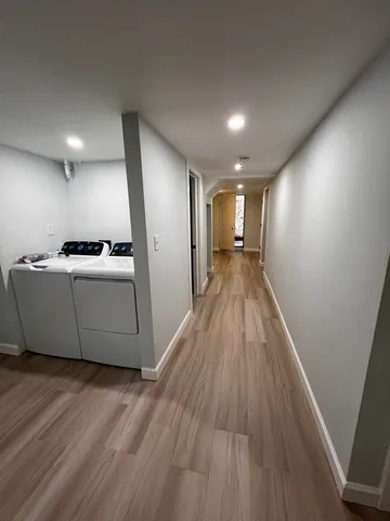 a view of a hallway with wooden floor
