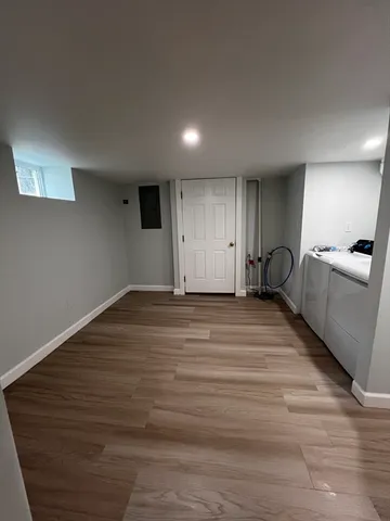 a view of empty room with wooden floor